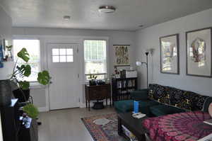 Living area with a textured ceiling and wood-type flooring