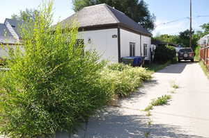 View of home's exterior featuring concrete driveway and board and batten siding