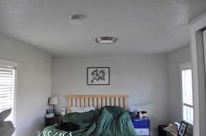 Bedroom with a textured ceiling