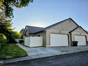 View of front facade with an attached garage, concrete driveway, and a shingled roof