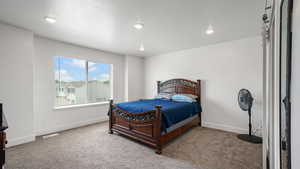 Bedroom with carpet, baseboards, and recessed lighting
