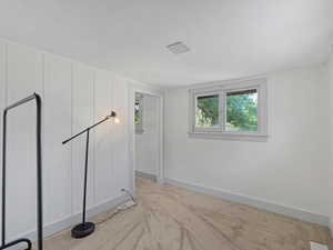 Spare room with light carpet and baseboards