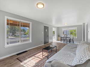Living area featuring baseboards and wood finished floors