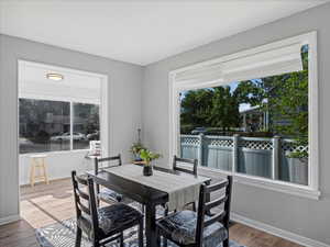 Dining area featuring wood finished floors, healthy amount of natural light, and baseboards