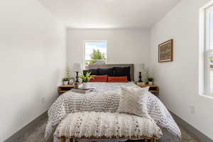 Carpeted bedroom featuring baseboards