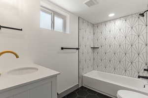 Full bathroom with tile patterned flooring, shower / bathtub combination, vanity, toilet, and recessed lighting