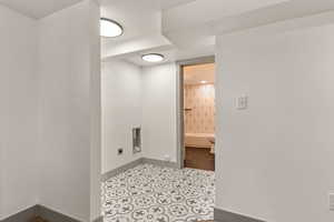 Laundry area with electric dryer hookup and baseboards