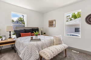 Bedroom featuring carpet flooring and baseboards
