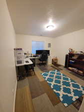 Office space with baseboards and a textured ceiling
