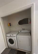 Laundry area with washing machine and clothes dryer and baseboards