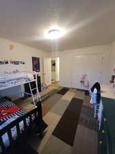 Carpeted bedroom featuring a closet