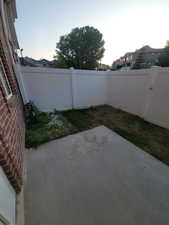 Fenced backyard with a patio