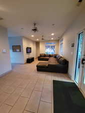 Living area with light tile patterned floors, recessed lighting, and baseboards