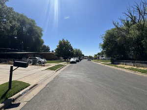 West View of asphalt street with curbs and sidewalks