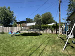 View of yard with a trampoline