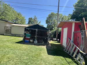 View of grassy yard with an outdoor structure