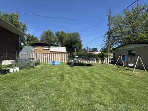 View of yard with a trampoline and an outdoor structure