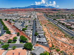 Aerial view of property's location featuring a mountain backdrop and nearby suburban area