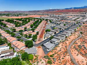 Aerial view of property's location featuring mountains and nearby suburban area