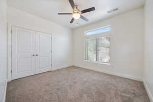 Unfurnished bedroom with carpet flooring, baseboards, a closet, and ceiling fan