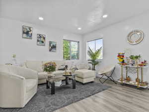 Living room with wood finished floors and recessed lighting