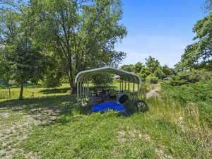 View of yard with a detached carport