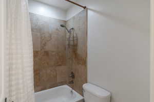 Bathroom with shower / bath combo and toilet