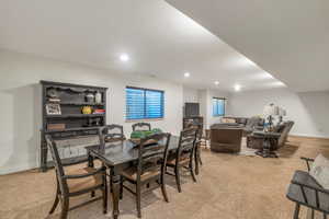 Dining room with light carpet, recessed lighting, and baseboards