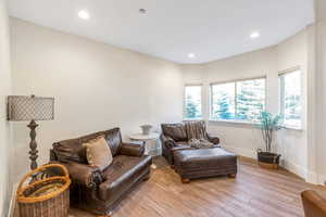 Sitting room with light wood-style flooring, baseboards, and recessed lighting