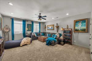 Living room with carpet, a ceiling fan, and recessed lighting