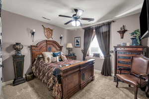 Bedroom with light colored carpet, ceiling fan, and baseboards