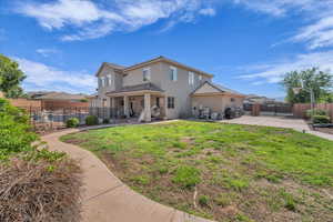 Rear view of house with a patio, a gate, stucco siding, and a tiled roof