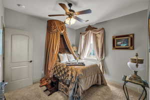 Bedroom featuring carpet, ceiling fan, and baseboards