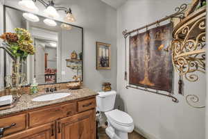 Bathroom featuring vanity, toilet, and tile patterned floors