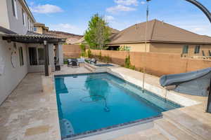 View of swimming pool featuring a fenced backyard, a pergola, a water slide, and a patio