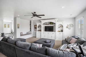Living room with light carpet, ceiling fan, recessed lighting, and baseboards