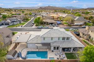 Aerial view of residential area featuring a pool area and a mountainous background
