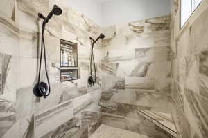 Bathroom featuring tiled shower
