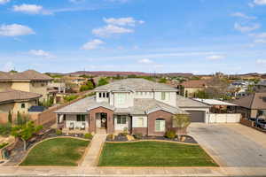 View of front of home with a residential view, brick siding, and concrete driveway