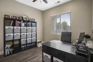 Office space with ceiling fan and dark wood-style floors