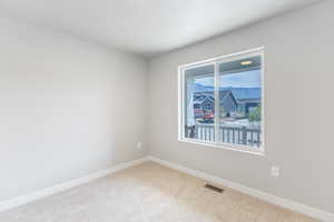 Unfurnished room featuring carpet and baseboards