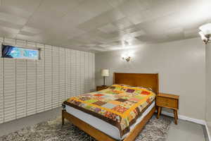 Bedroom featuring tile walls