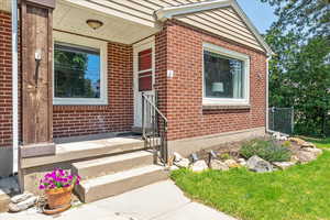 Doorway to property with brick siding