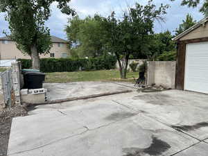 View of patio / terrace with a garage and concrete driveway