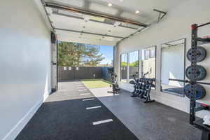 Garage featuring baseboards and recessed lighting