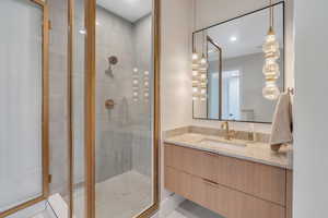 Bathroom with a stall shower, vanity, and tile patterned flooring