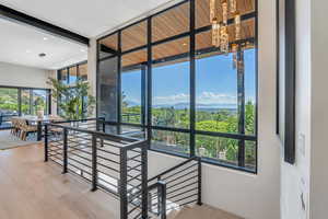 Staircase featuring wood finished floors, a chandelier, and recessed lighting