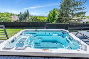 View of swimming pool featuring an outdoor hot tub and a mountain view