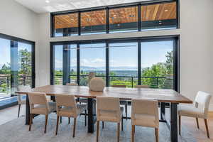 Dining space with light wood finished floors and recessed lighting