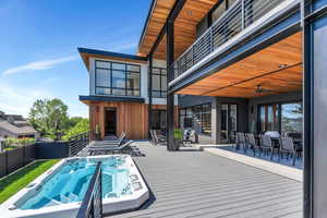 View of pool with outdoor dining area and a deck